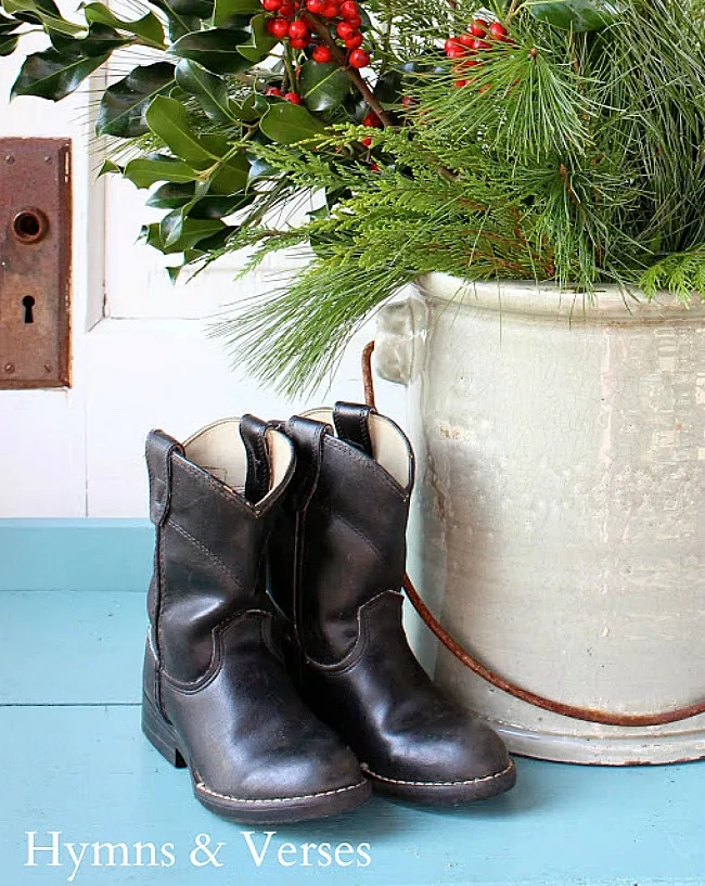 Vintage children's cowboy boots with a crock of Christmas greens - Hymns and Verses Blog