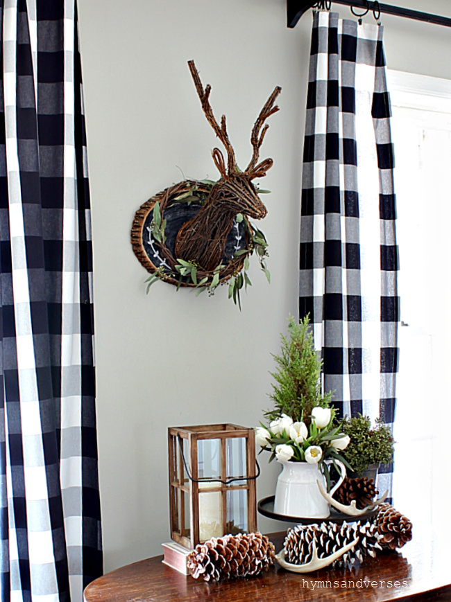 Winter Vignette with stag head, pinecones, antlers, lantern, and more