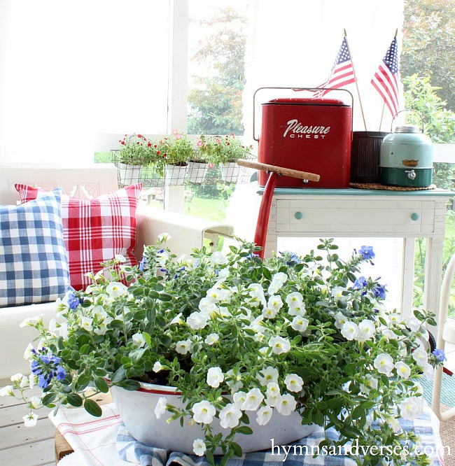Red white and blue summer porch with vintage coolers and American flags.