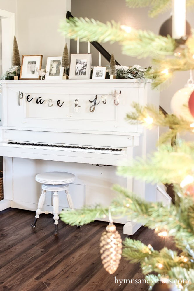 Vintage player piano decorated for Christmas - black, white, and burgundy decor