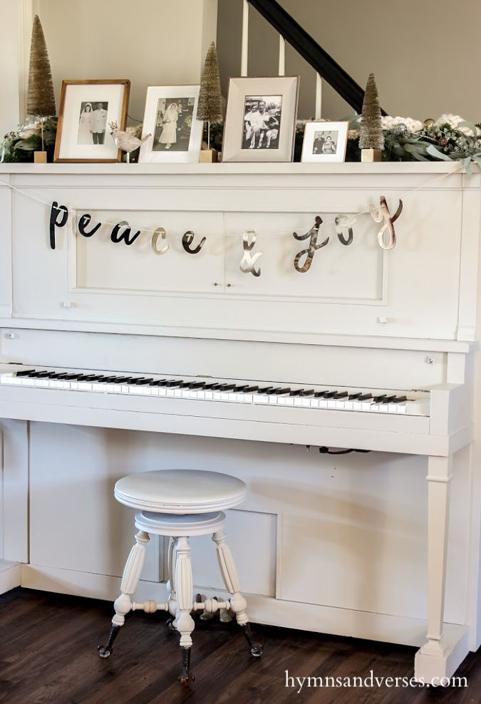 Vintage player piano with peace and joy bunting - black, white, and burgundy decor