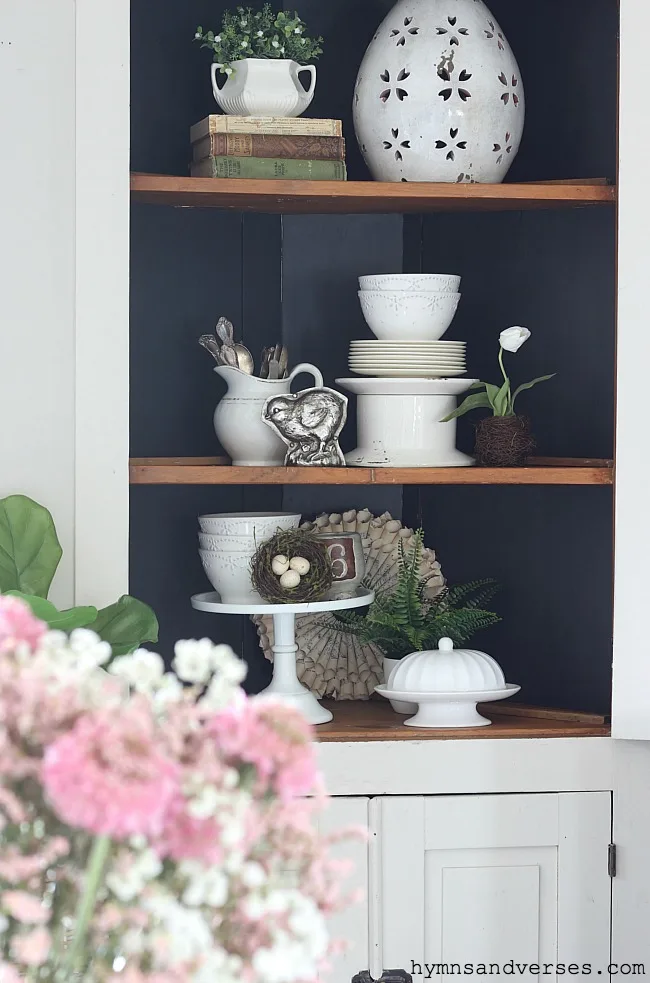 Interior of antique corner cabinet styled for spring