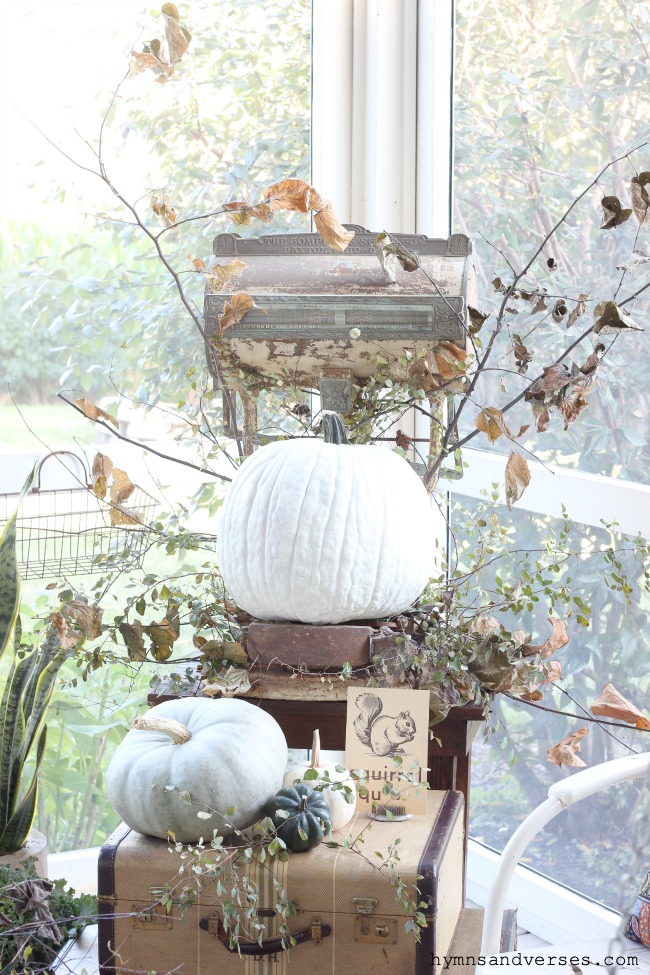 Fall porch decor with vintage scale and suitcases