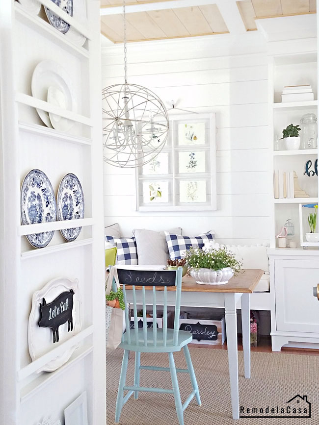 Plate rack on the side of fridge with dining room farmhouse decor