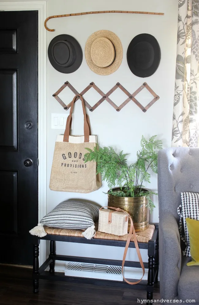 Entryway with vintage accordion coat rack and vintage hats and cane - Hymns and Verses Blog