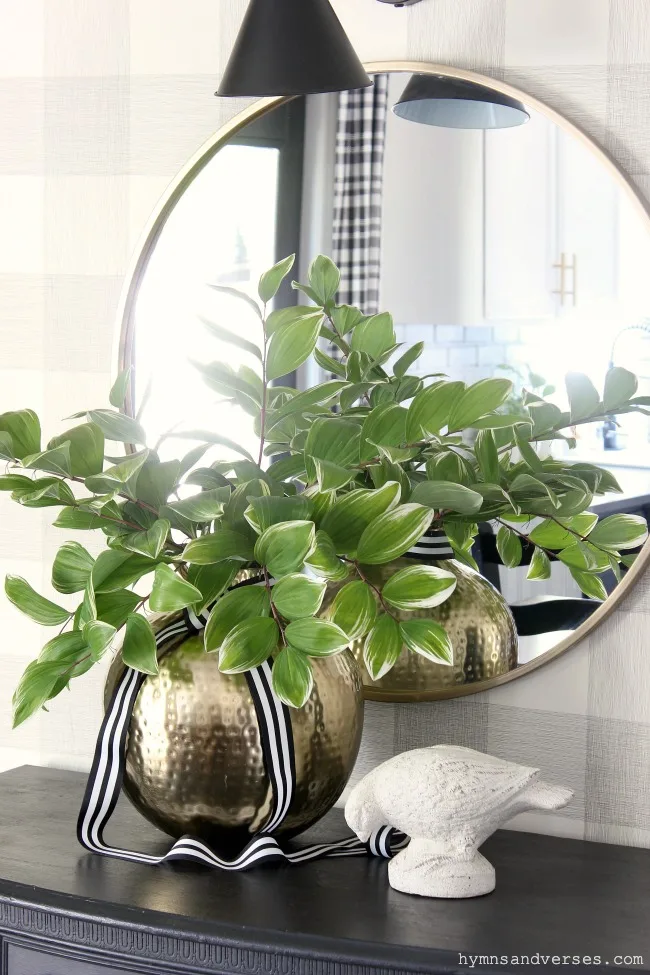 Buffet styled for summer with vase of Solomon's Seal branches and distressed concrete bird - Hymns and Verses Blog