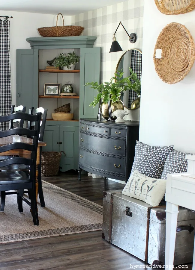 Green painted antique corner cabinet and black painted dresser in modern farmhouse dining room - Hymns and Verses Blog