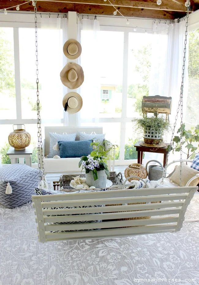 Summer screened porch with vintage metal glider and chairs and vintage porch swing - Hymns and Verses Blog