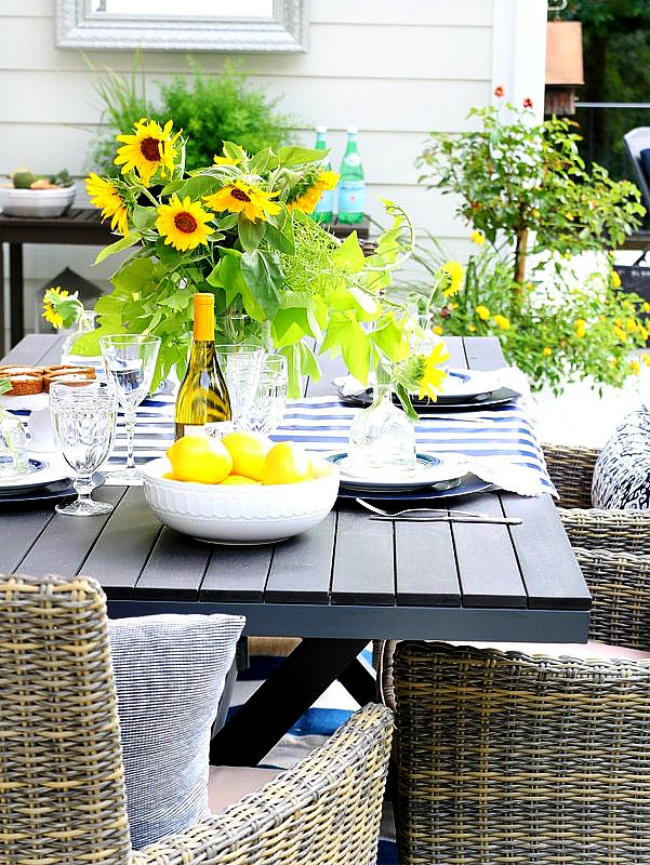 yellow and blue tablescape with lemons and sunflowers