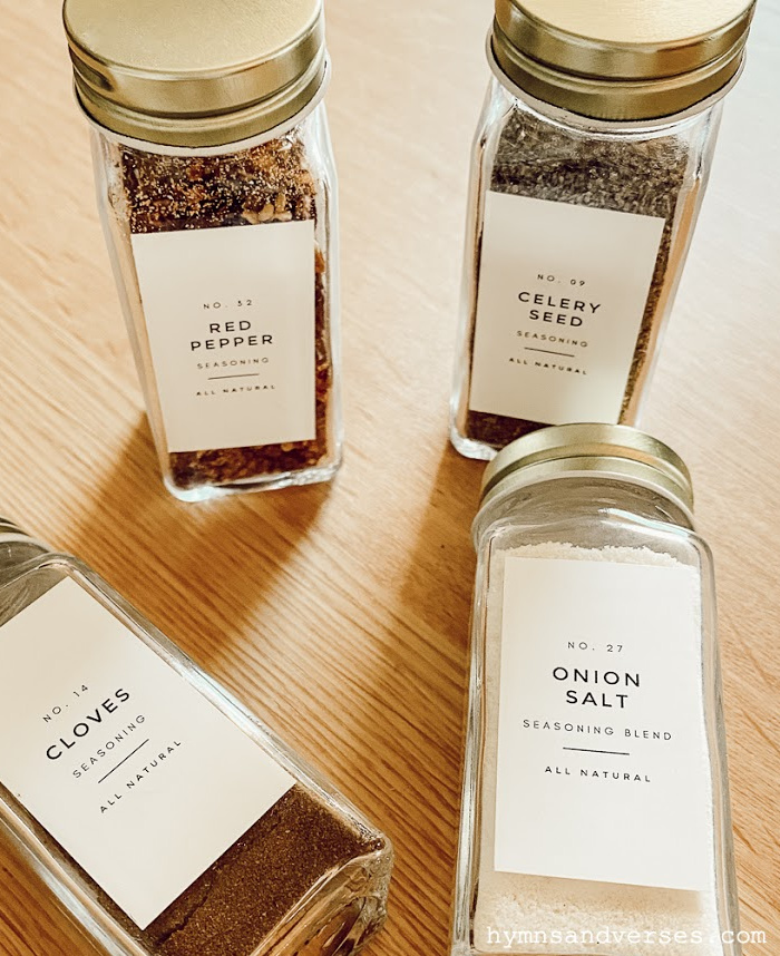 Pretty glass spice jars with gold lids and labels.