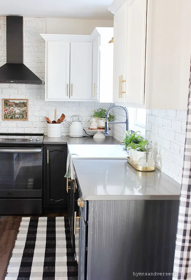 Black and White Kitchen with Painted Brick Backsplash
