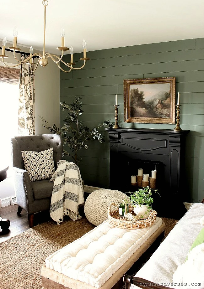 Green shiplap wall with black mantel