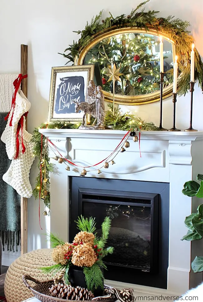 Living room fireplace mantel with vintage, gold framed, oval mirror above mantel.