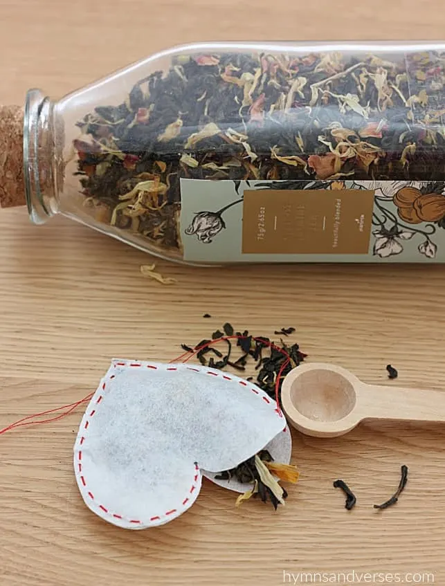 Filling a heart shaped tea bag with loose leaf tea.