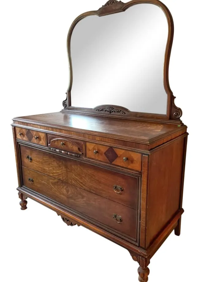 Wood finish antique dresser with mirror.