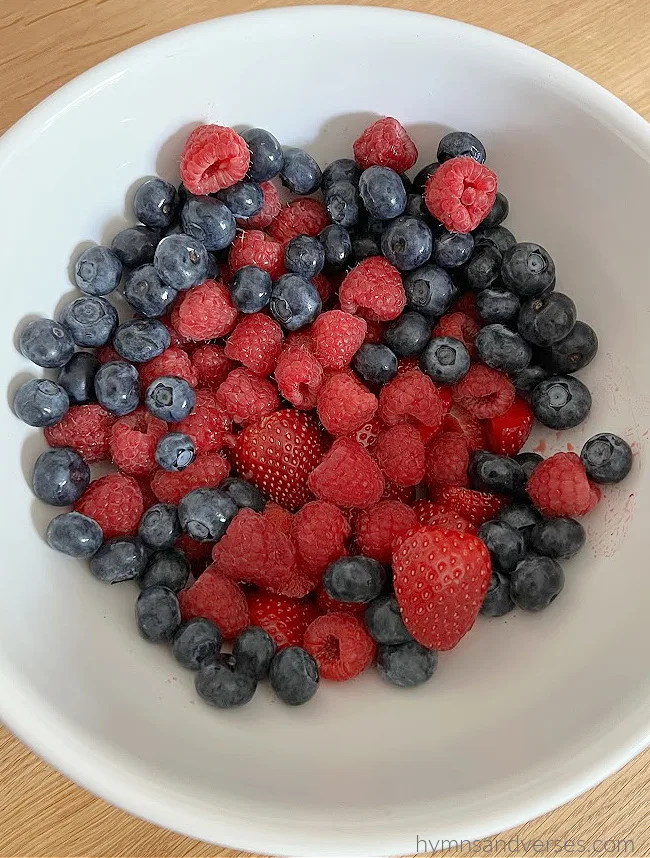 Bowl of mixed summer berries - strawberry, blueberry, and red raspberry